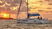 Crew sailing Sun Odysset 490 during sunset